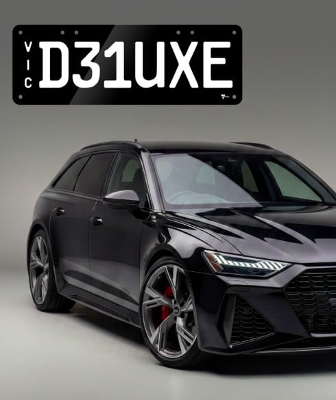 A car with a Deluxe style plate