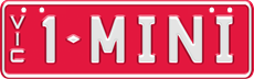 Custom plate slimline - white embossed text on red background, two sets of characters separated by a diamond divider (for example 1- MINI), with VIC vertically down on the left side. Eight screws on the edges of the plate