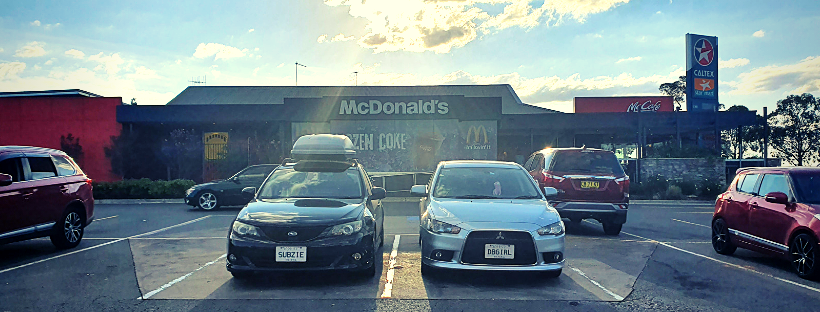 Two cars at a Maccas car park