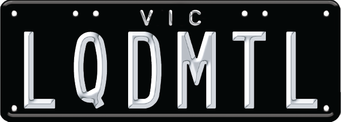 Liquid metal plate - silver text on a black background, with VIC at the top centre. Eight screws on the edges of the plate